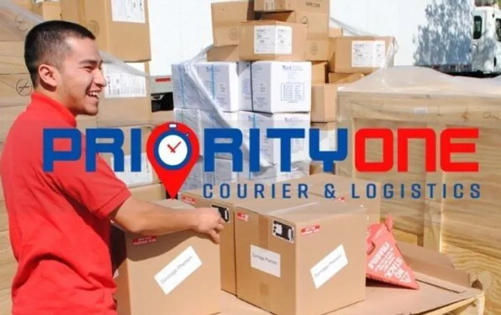 A man standing in front of boxes on top of a truck.